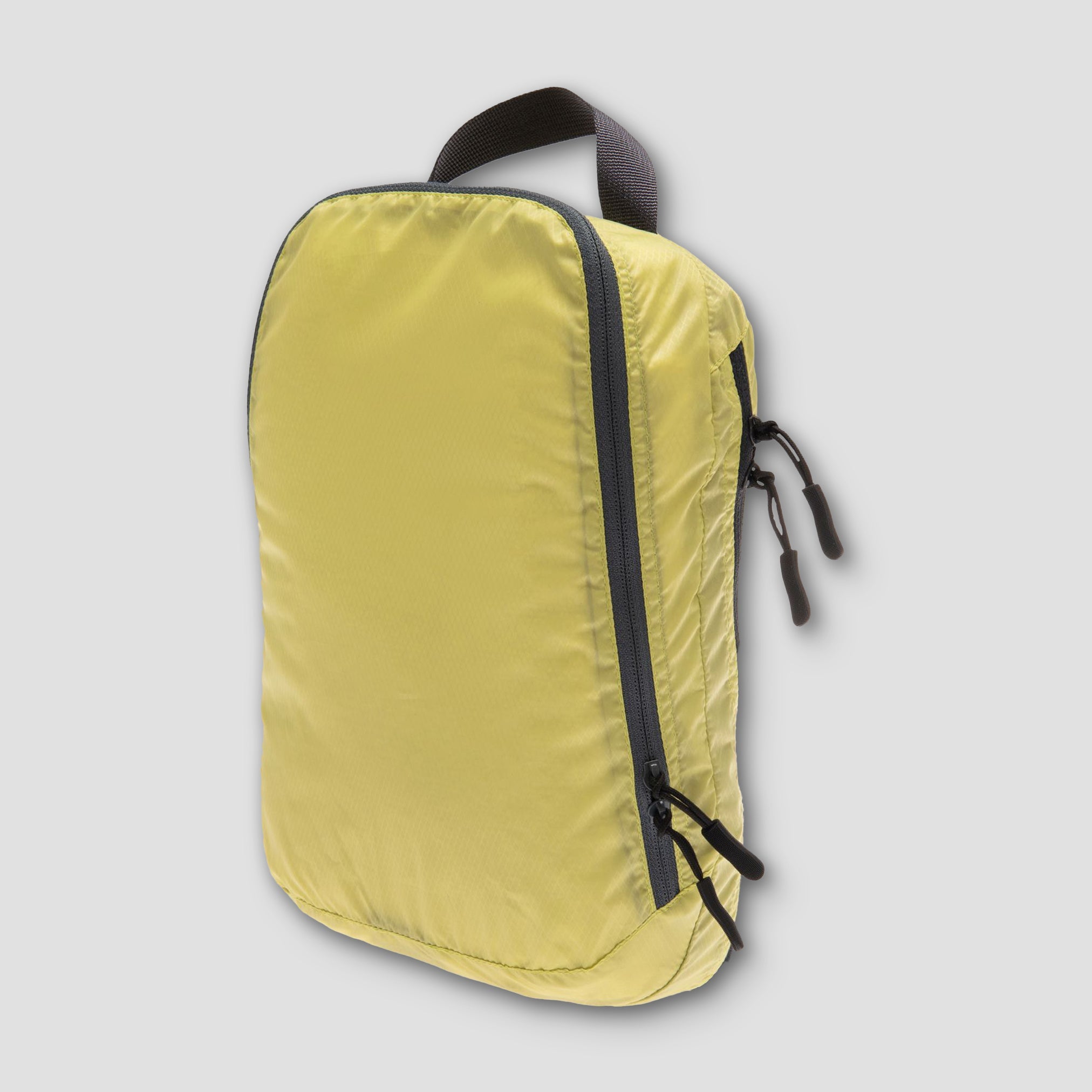 Light two-in-one separated packing cube from COCOON with multiple compartments for organized travel storage.